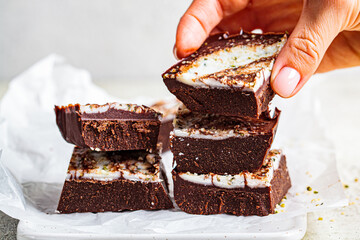 Raw vegan chocolate bars with nuts and seeds. Healthy sugar-free dessert.
