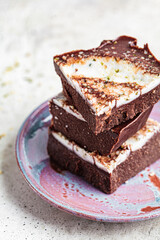 Raw vegan chocolate bars with nuts and seeds. Healthy sugar-free dessert.