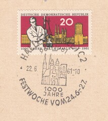 Scientist on the background of city. 1000 years Halle (Saale), stamp Germany 1961