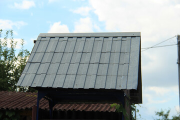 icon roof with new brown roofing tiles on residential property. banner on  roof for roofers....