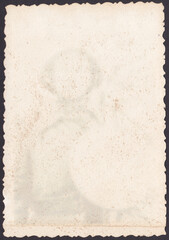 Reverse side of vintage photos with translucent silhouette of a soldier against. Texture retro cardboard, background