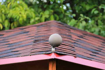 icon roof with new brown roofing tiles on residential property. banner on  roof for roofers....