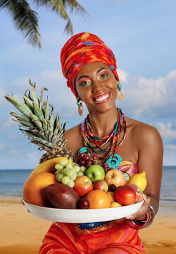 Portrait Of Sweet Black Woman With A Tray Of Fruit On The Beach