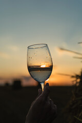 Glass of white wine at sunset