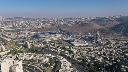 Obraz premium Teddy and Arena Stadium in Jerusalem Aerial view Malha neighbourhood and Arena Basketball Stadium, Begin road,South West Jerusalem, Israel 