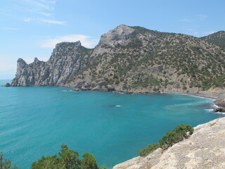 Scenic view of the blue sea, sky against the backdrop of beautiful rocks surrounding the Blue Bay on a summer sunny day