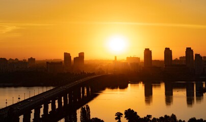 Big city at sunset, silhouettes of houses