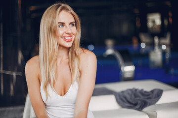 Woman in a spa salon. Blonde in a white swimsuit