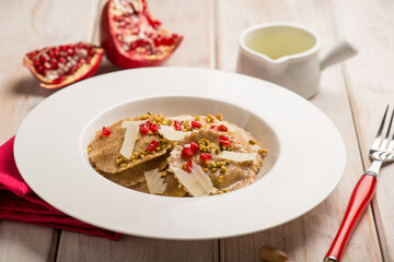 artichoke ravioli with pomegranate and parmisan flakes