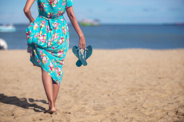 Fototapeta na wymiar young woman walking on the beach