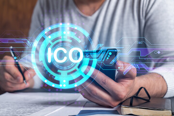 Multiexposure of man signing contract with phone and ico hologram. Concept of initial coin...