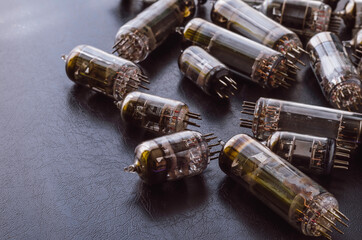 Random vacuum tubes on a black background.