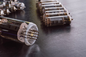 Random vacuum tubes on a black background.