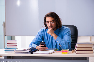 Young male teacher in the classroom