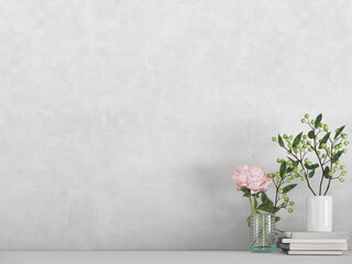Modern room decoration. flower,  plant and books on white shelf, table against white colored wall. 