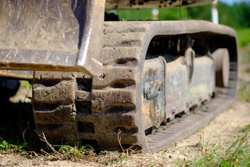 Dirty excavator track on the ground