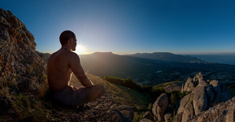 Naklejka na ściany i meble traveler meditate on mountain