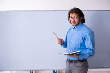 Young male teacher in the classroom