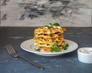 Zucchini shoes with the addition of cheese on a light plate top view