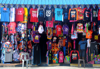 Fototapeta premium PORT DICKSON, MALAYSIA -MARCH 3, 2020: Clothes for sale, hung in front of the store to attract customers. There are a variety of attractive sizes and designs. 