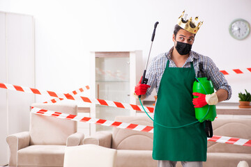 Young male sanitizer disinfecting indoors