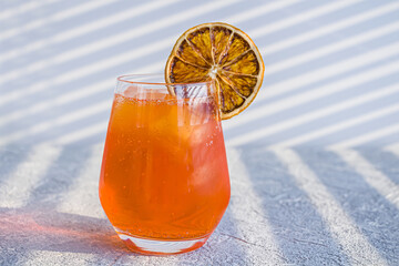 Orange alcoholic cocktail with whiskey, liqueur and orange peel.  Summer refreshing orange drink...
