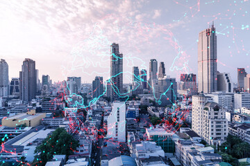 Fototapeta premium Glowing hologram of Earth planet map on aerial panoramic cityscape of Bangkok at sunset, Asia. The concept of international business. Multi Exposure.