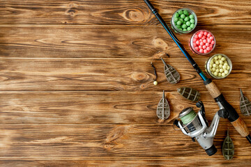 Accessories for carp fishing and fishing baits on wooden planks with copy space