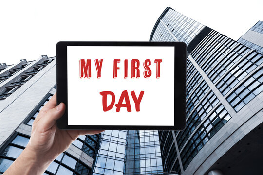 Start new job. Man holding tablet with text My First Day against modern building, closeup