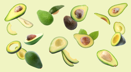 Fresh ripe avocados falling on light background, banner design