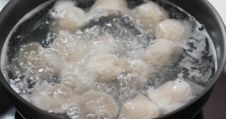 Cooking with meat dumpling in kitchen