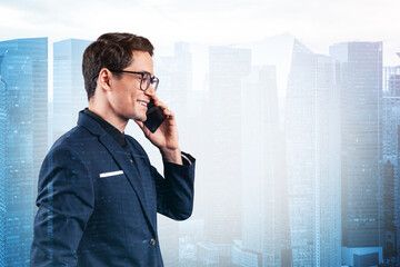 Prosperous handsome entrepreneur in suit and glasses pensively talking phone and looking on...