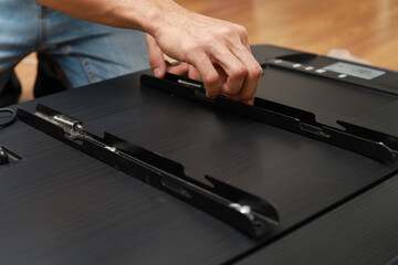 Cropped Hand Of Man Fitting Bracket For Flat Screen TV