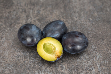 Plum. Fresh plum. Harvest. Autumn harvest. Autumn. Blue plums. Fresh plums on conctrete surface