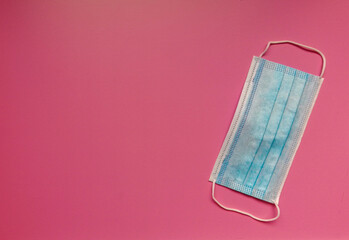 medical mask on pink background. Protection concept  in the time of coronavirus