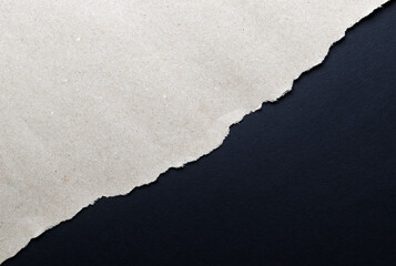 Dark paper with torn edges isolated on a black background of colored paper inside. Good paper...