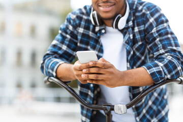 Cropped portrait of african american guy using his cell phone