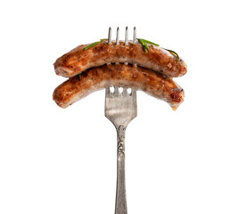 Cooked sausage chipolatas on a fork isolated on white background