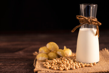 Soy products soy beans, soy milk, moon cake on black background