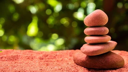Fotobehang Zen Stenen A pyramid of stones on the sand on the beach  © Zinesh