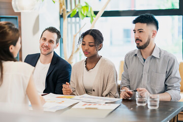 カジュアルな雰囲気のオフィス空間でミーティングするビジネスマンたち