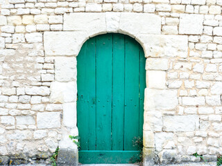 View of an ancient wall and an old green door - large image in high resolution