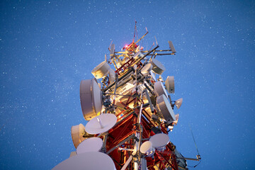 stars in night sky above radio tower