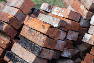 A stack of red not new fire bricks for laying a home stove