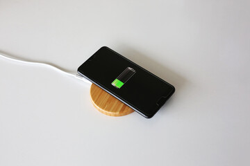 wireless charging and mobile phone on white background