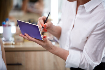 visagist, make-up artist use brush and decorative cosmetics during making make-up on model. beauty concept