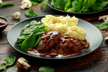 Salisbury Steak with mushroom gravy, mashed potatoes and spinach