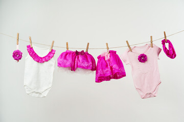 Baby clothes on a rope on a white background