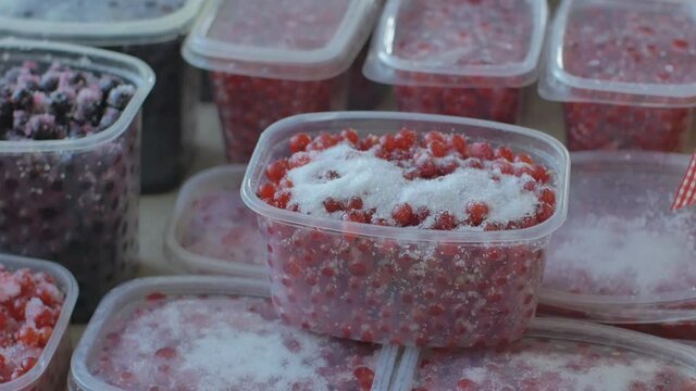 Tablespoon Sugar Sprinkled On Red Currant Berries In Plastic Containers.