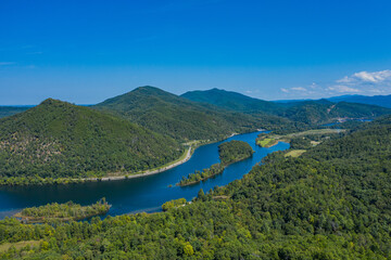 Fototapeta na wymiar landscape with river, mountains, and blue sky